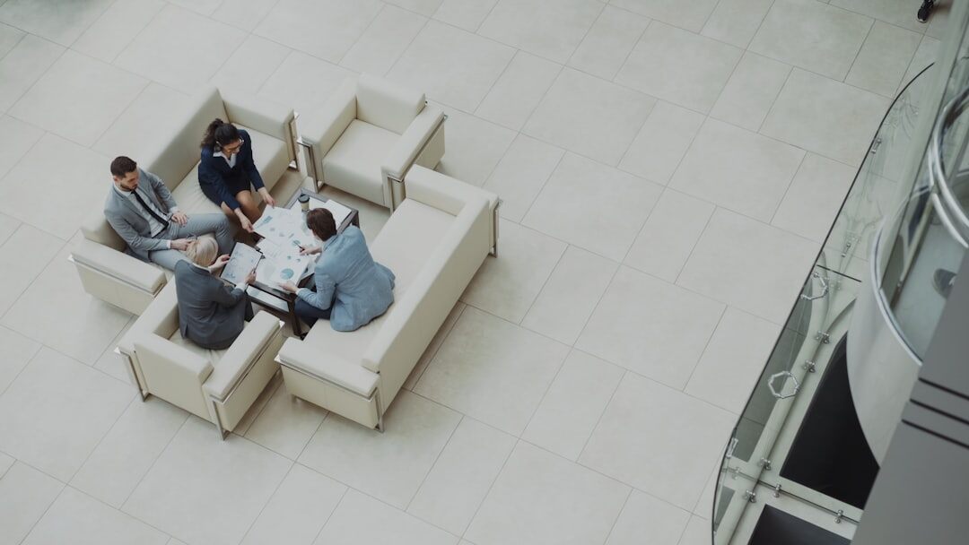 Team of business professionals meeting around a table viewed from above